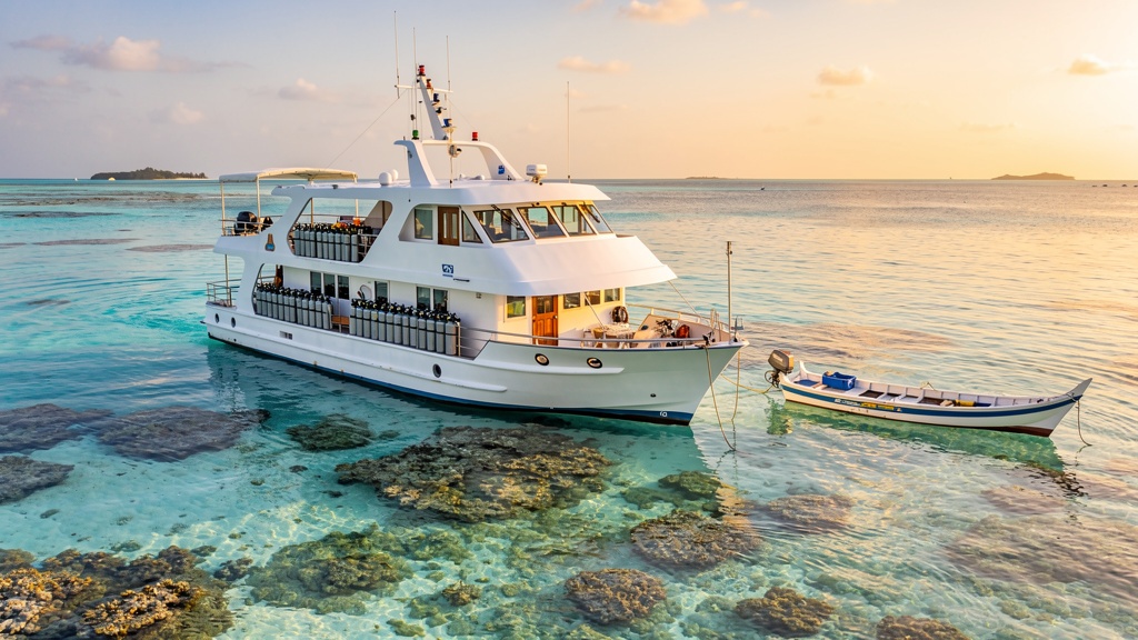 Liveaboard dive boat anchored in a calm lagoon